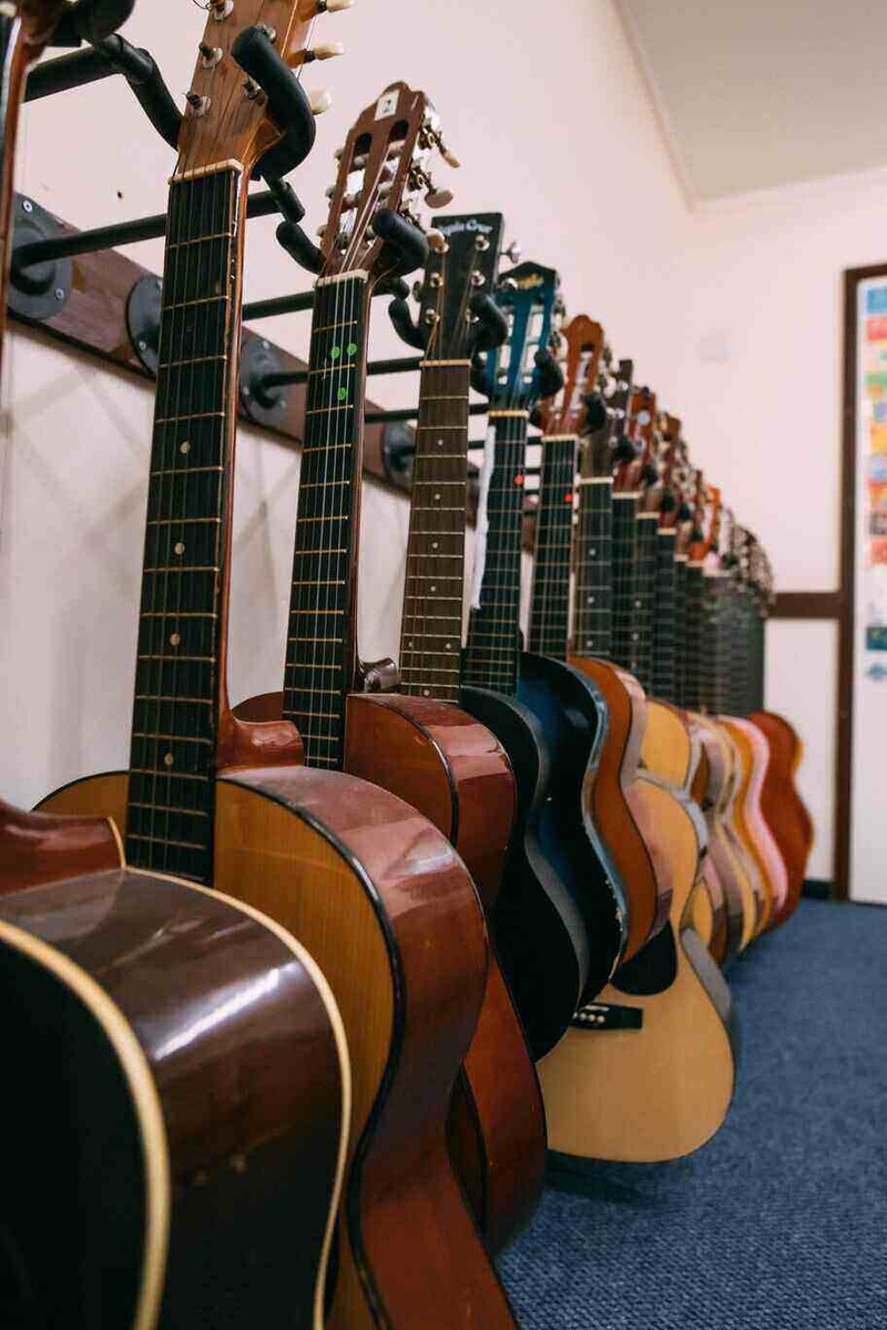 A row of guitars hanging up